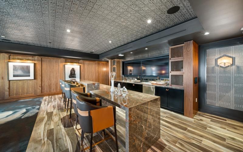 a kitchen with a bar and chairs