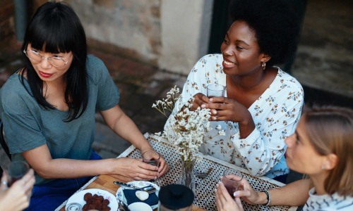 a group of women sitting at a restaurant