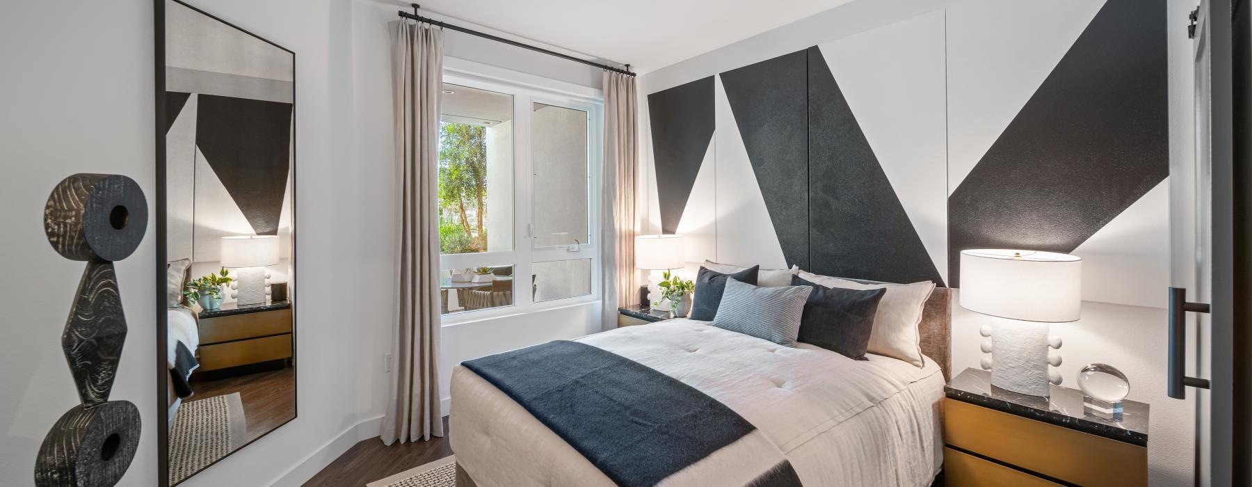 a bedroom with a bed and a mirror